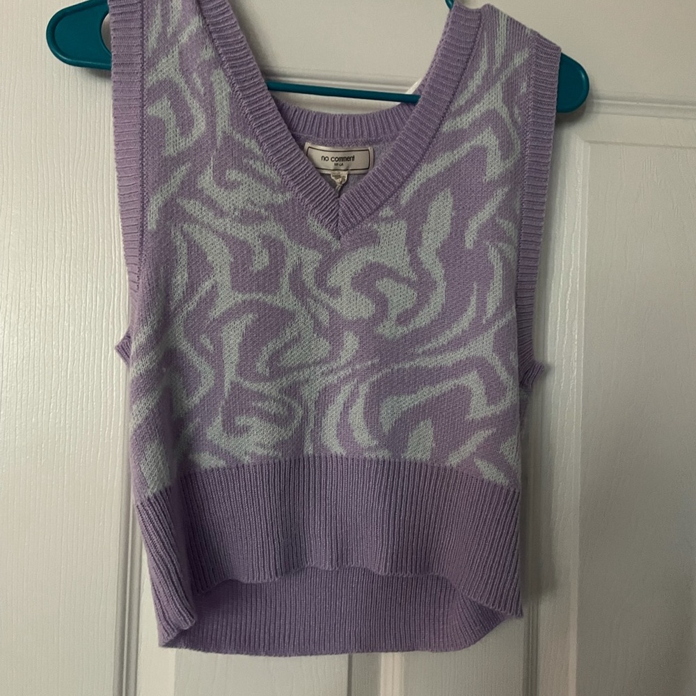 Houndstooth pattern sweater vest.